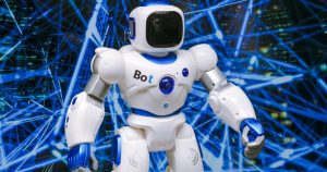 White toy robot standing amid blue string lights