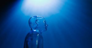 Translucent mannequin figure lit in blue, suggesting AI