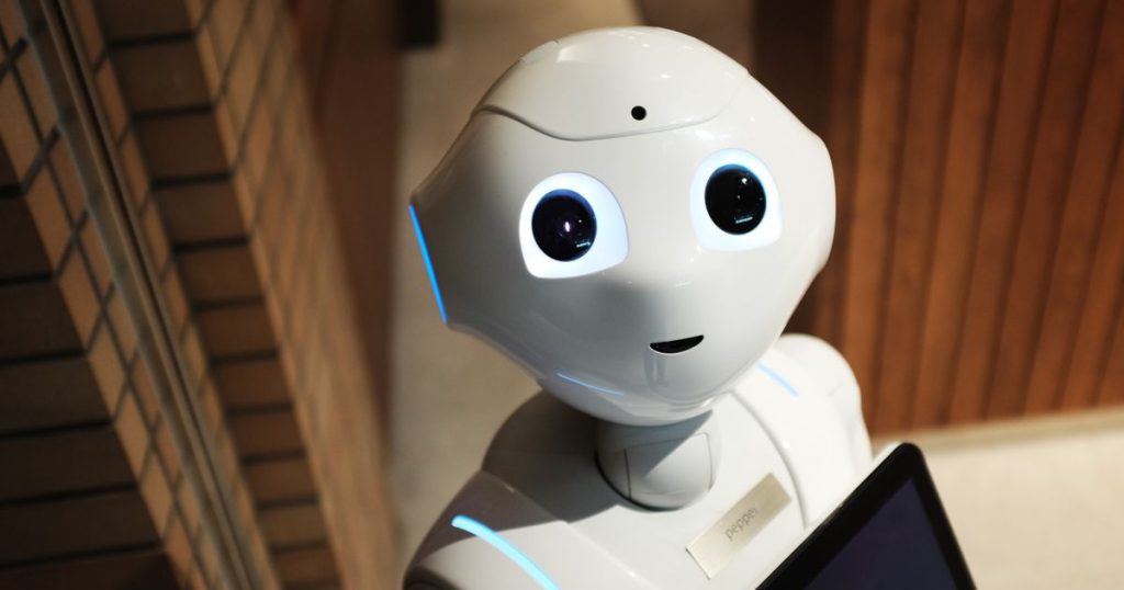 High-angle photo of a white robot on a dark background